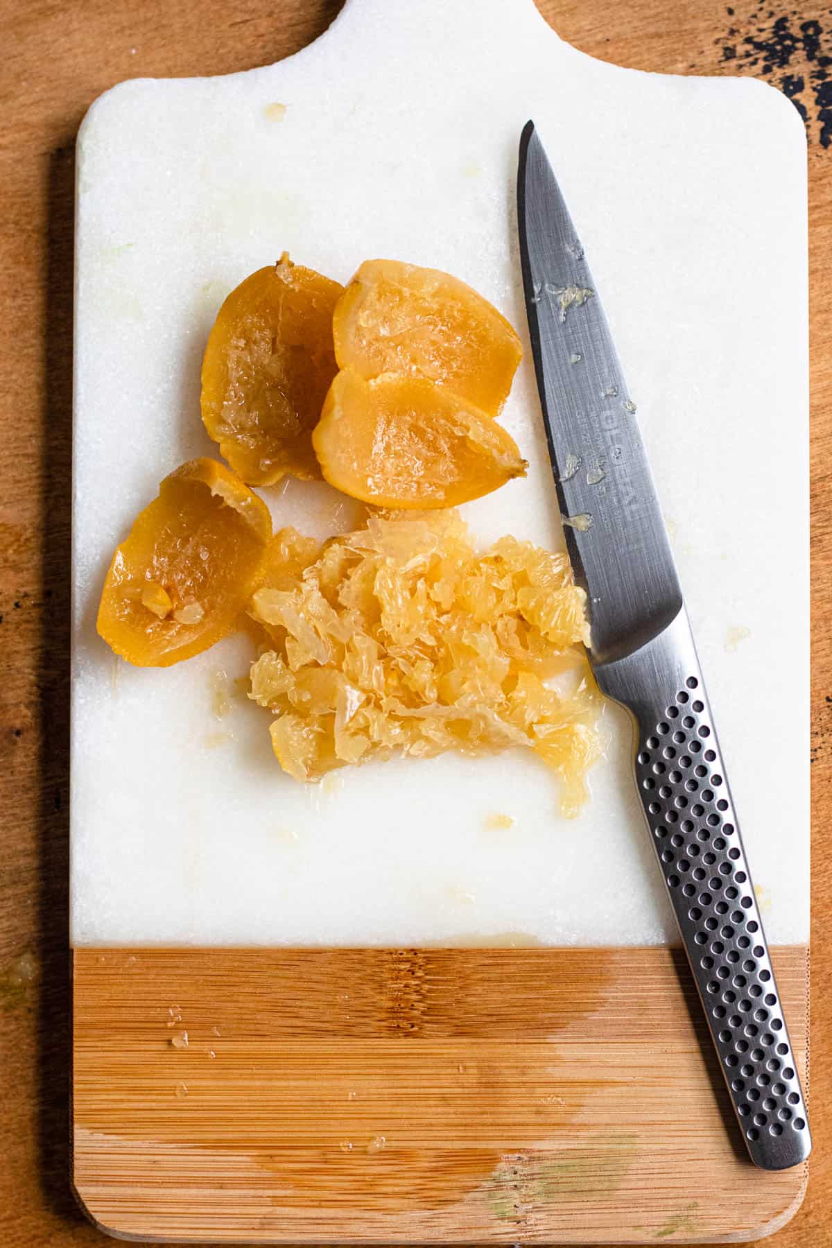 A chopped preserved lemon on a cutting board for flavoring the Moroccan chicken tagine recipe. 