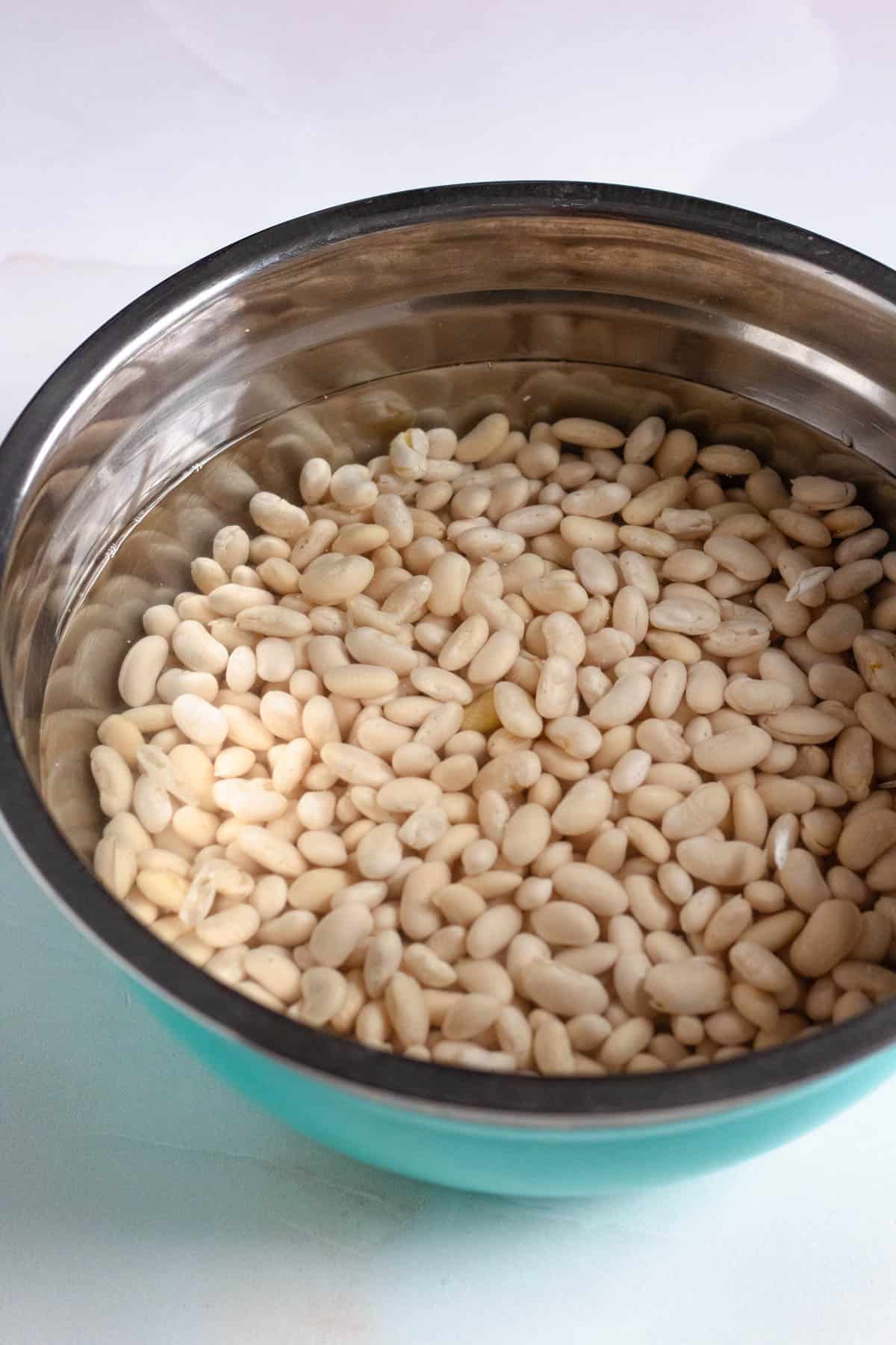 White cannellini beans soaking in water.
