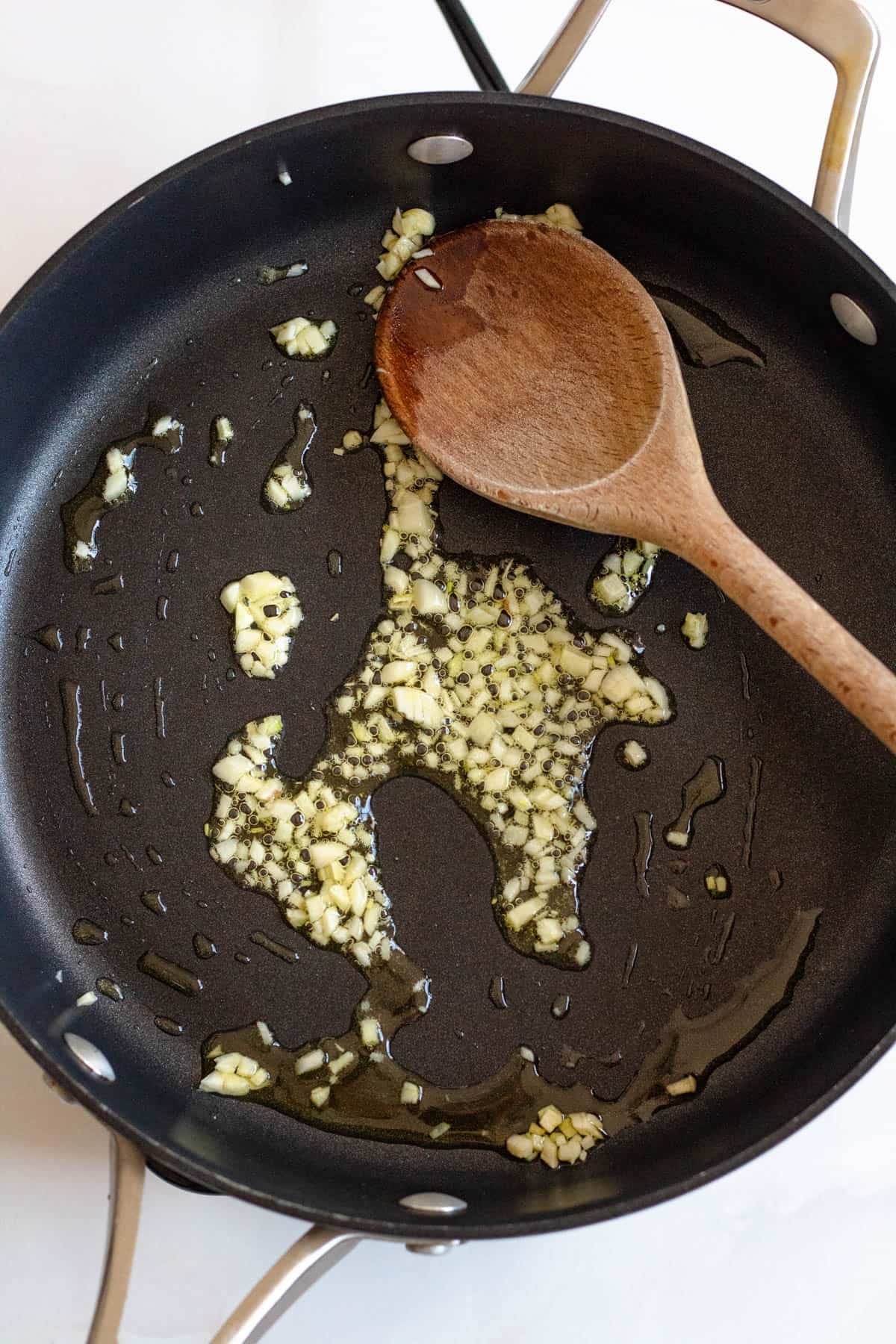 Minced garlic sauteing in a skillet. 