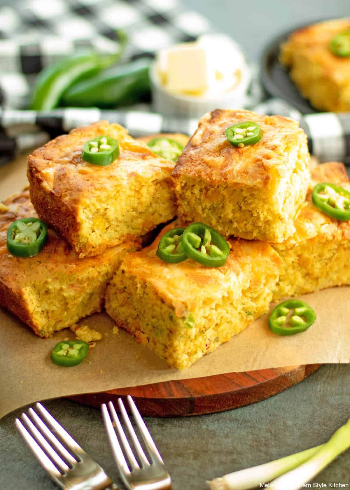 Squares of Mexican cornbread ganrished with slices of jalapenos. 