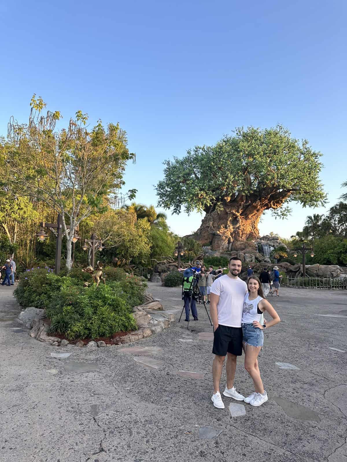 A couple posing in front of the Animal Kingdom tree.