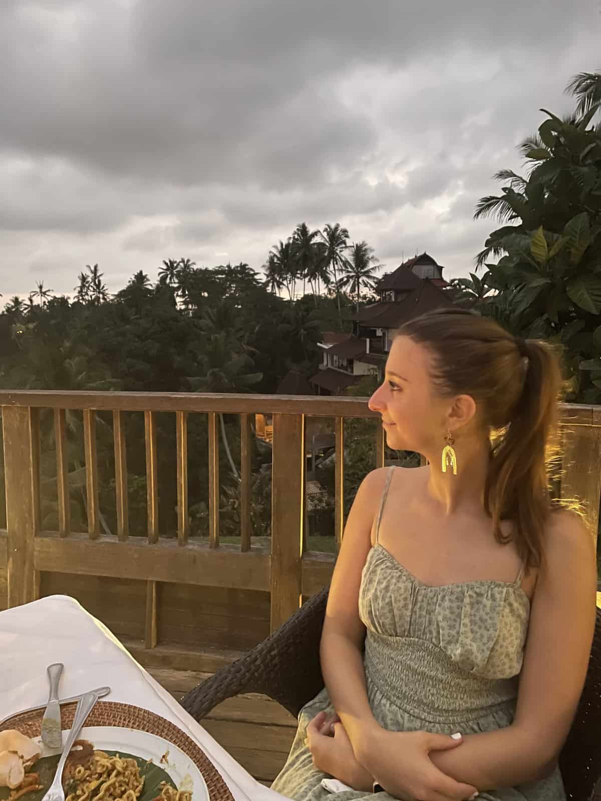 A woman looking out at the view from her dinner table. 