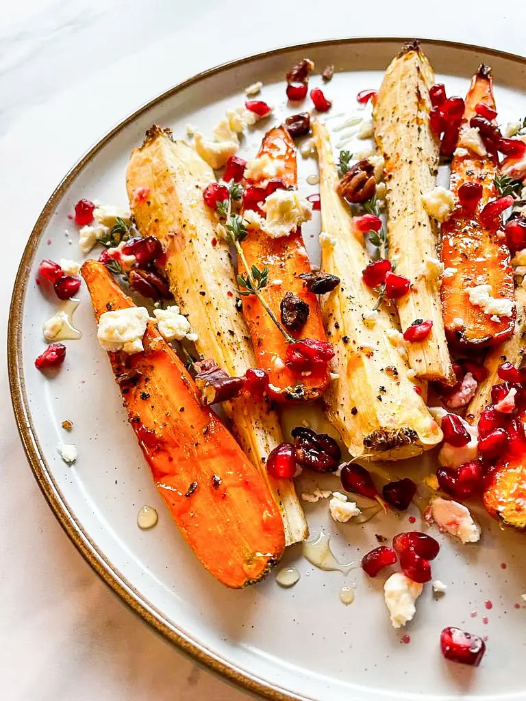 Plate filled with honey roasted carrots & parsnips. 