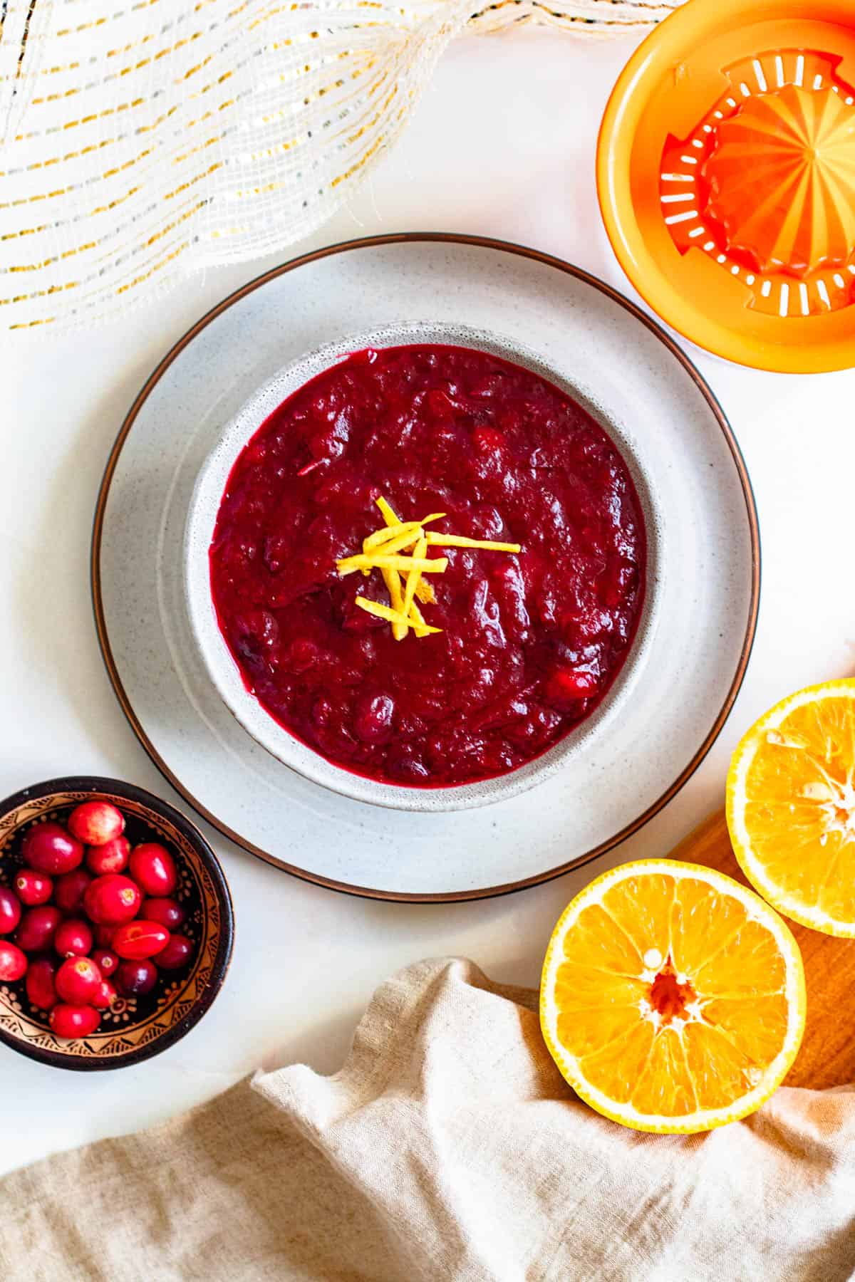 Top view of a bowl of instant pot cranberry sauce with orange zest over the top. 