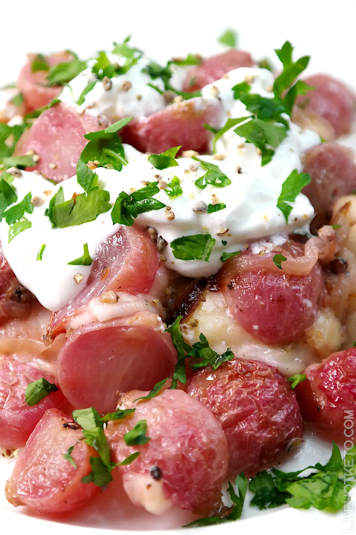 Loaded roasted radishes topped with sour cream and chopped parsley. 