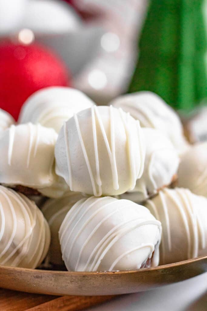 White chocolate drizzled gingerbread truffles plated and ready to serve. 