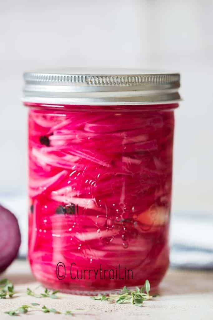 Pickled red onions in a closed mason jar. 