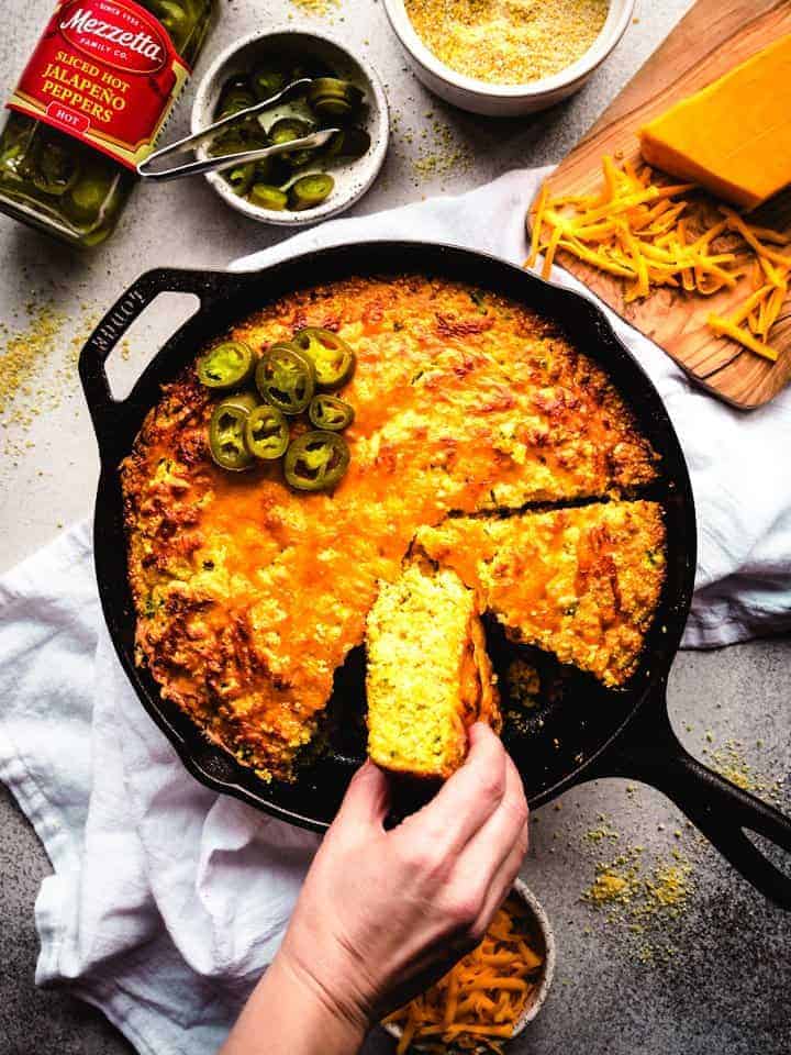 Jalapeno cheddar cornbread in a skillet and ready to serve. 
