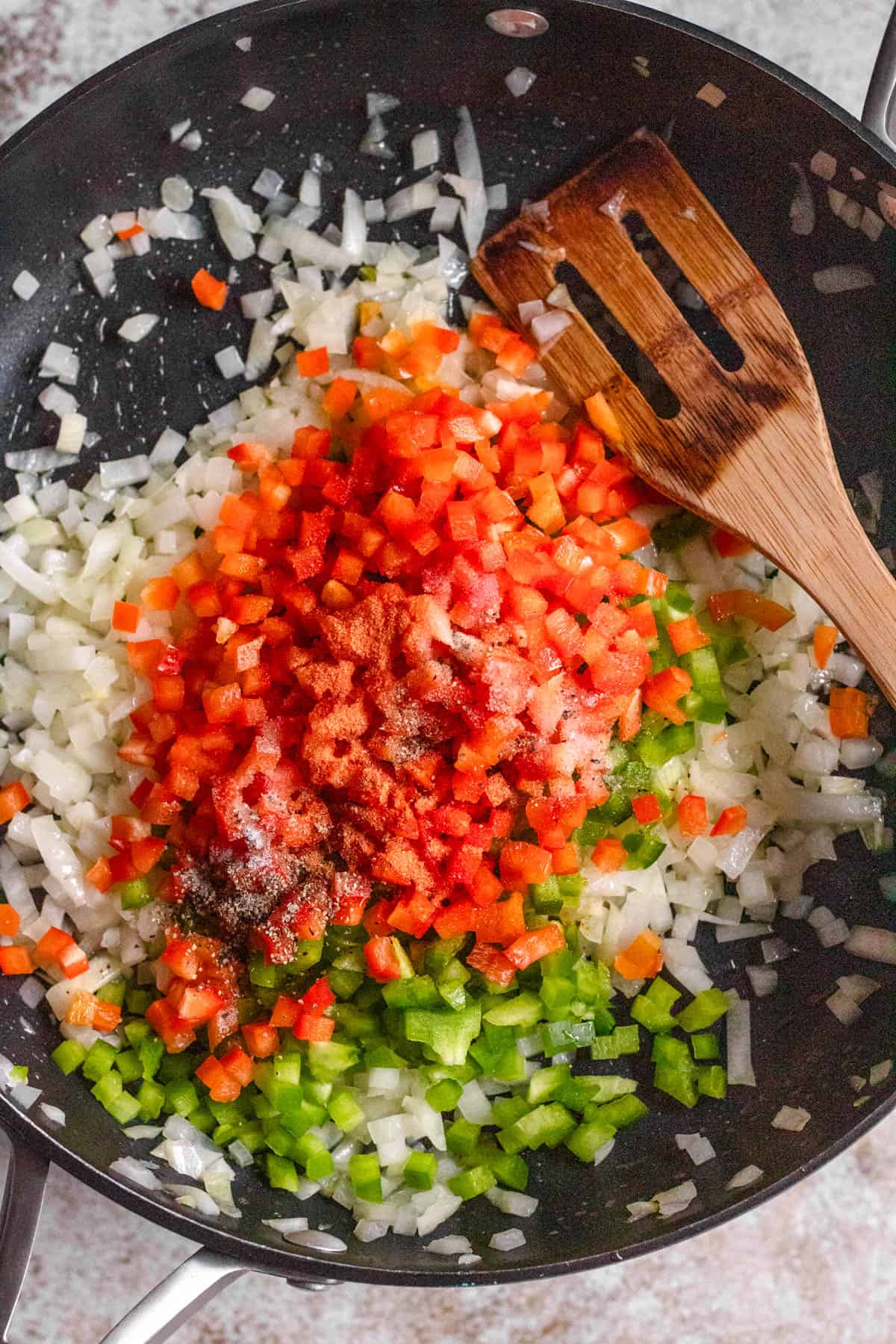 Diced vegetables to prepare the sofrito inside the skillet. 