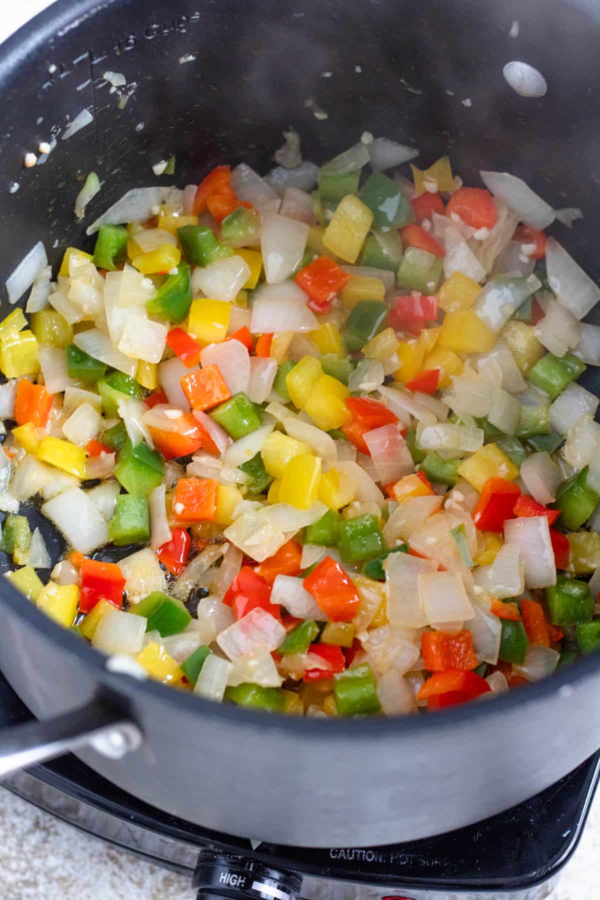 Diced bell peppers added to the onion mixture. 