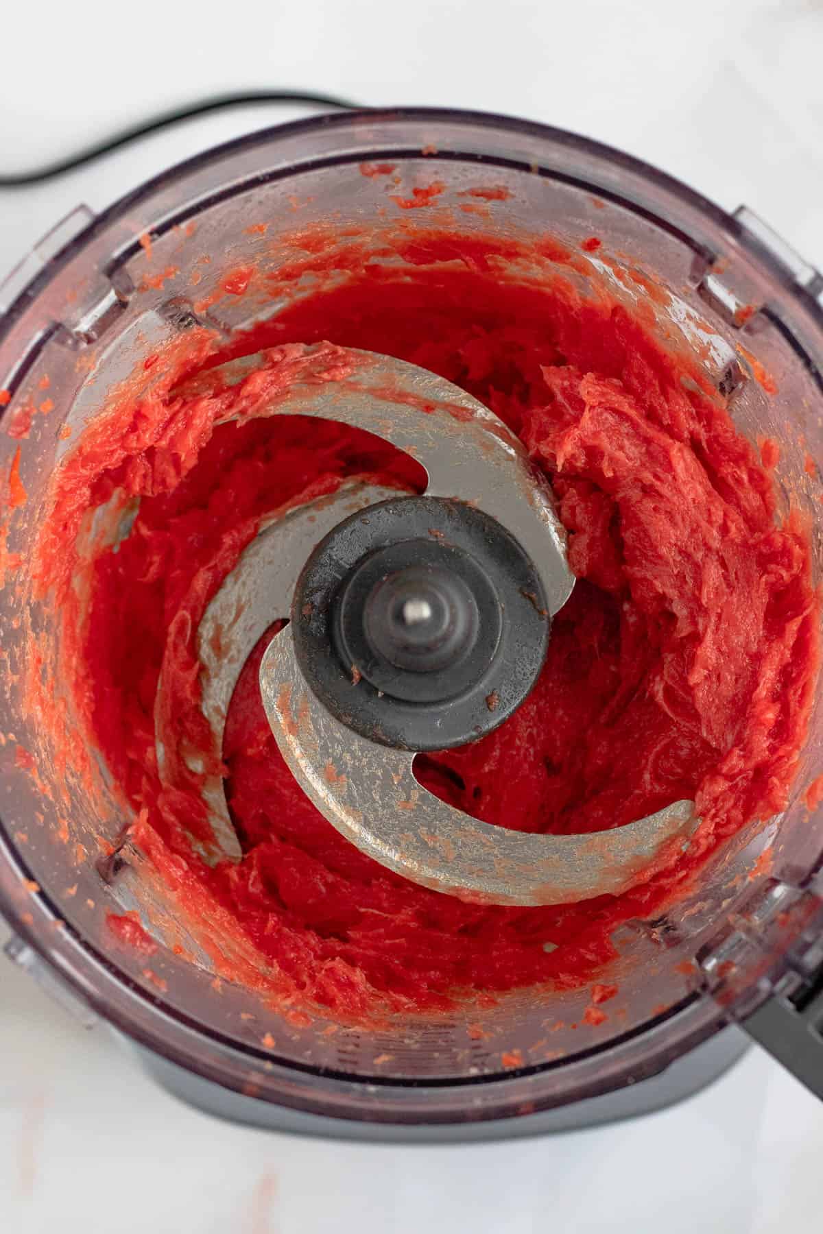 Meat and red bell pepper blended together in a food processor. 