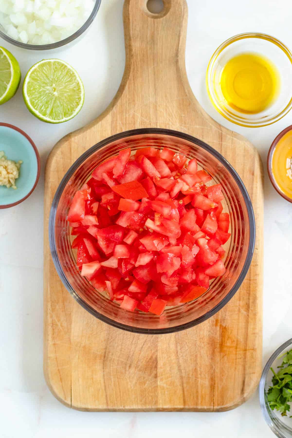 Diced roma tomatoes in a small glass bowl. 