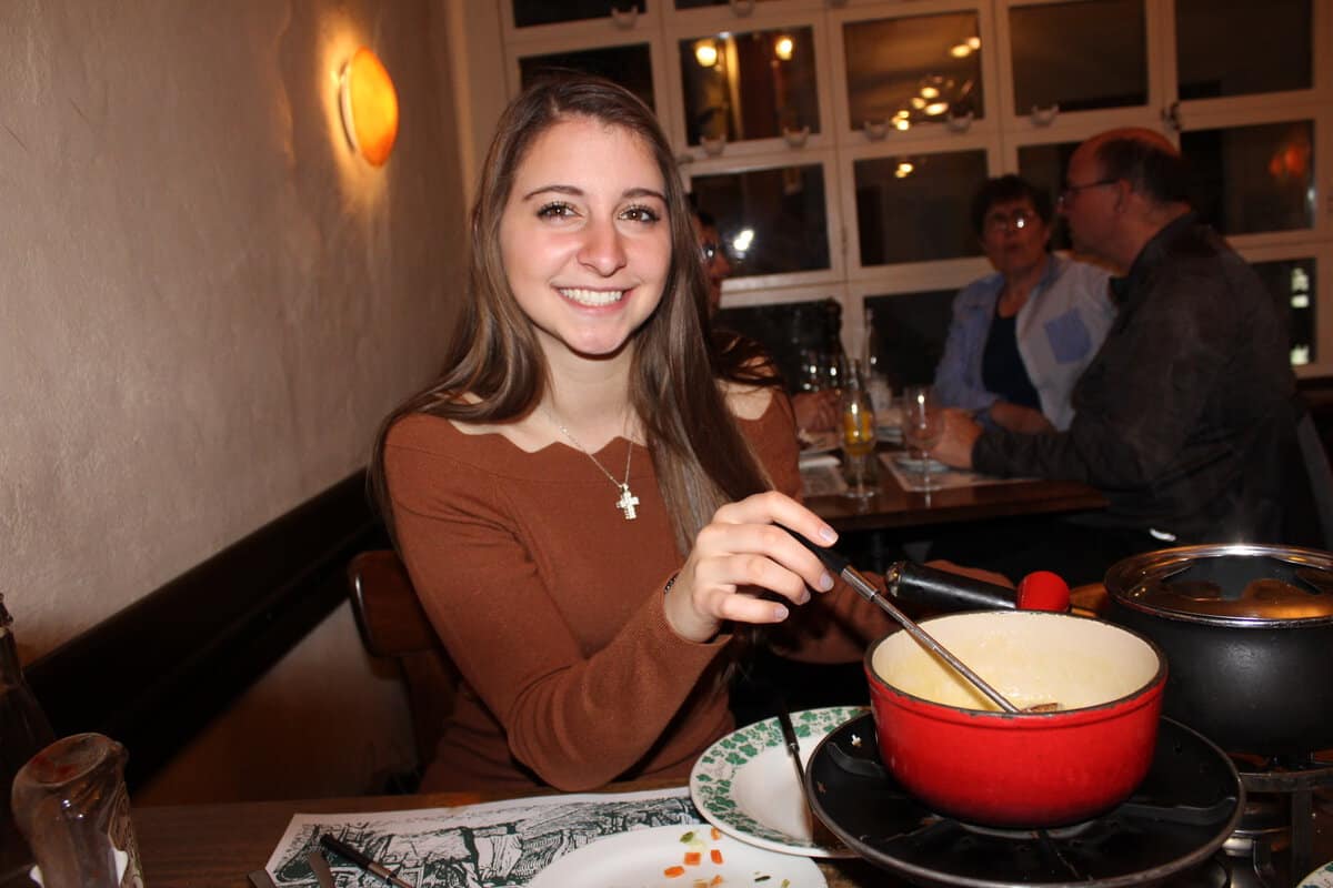 Alexandria enjoying fondue in Switzerland.