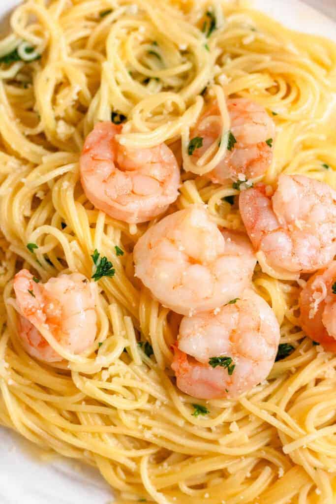 Close up of shrimp scampi on a bed of pasta.