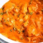 Butter chicken in a pot with sauce.