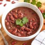 Stewed Beans in a bowl topped with cilantro.