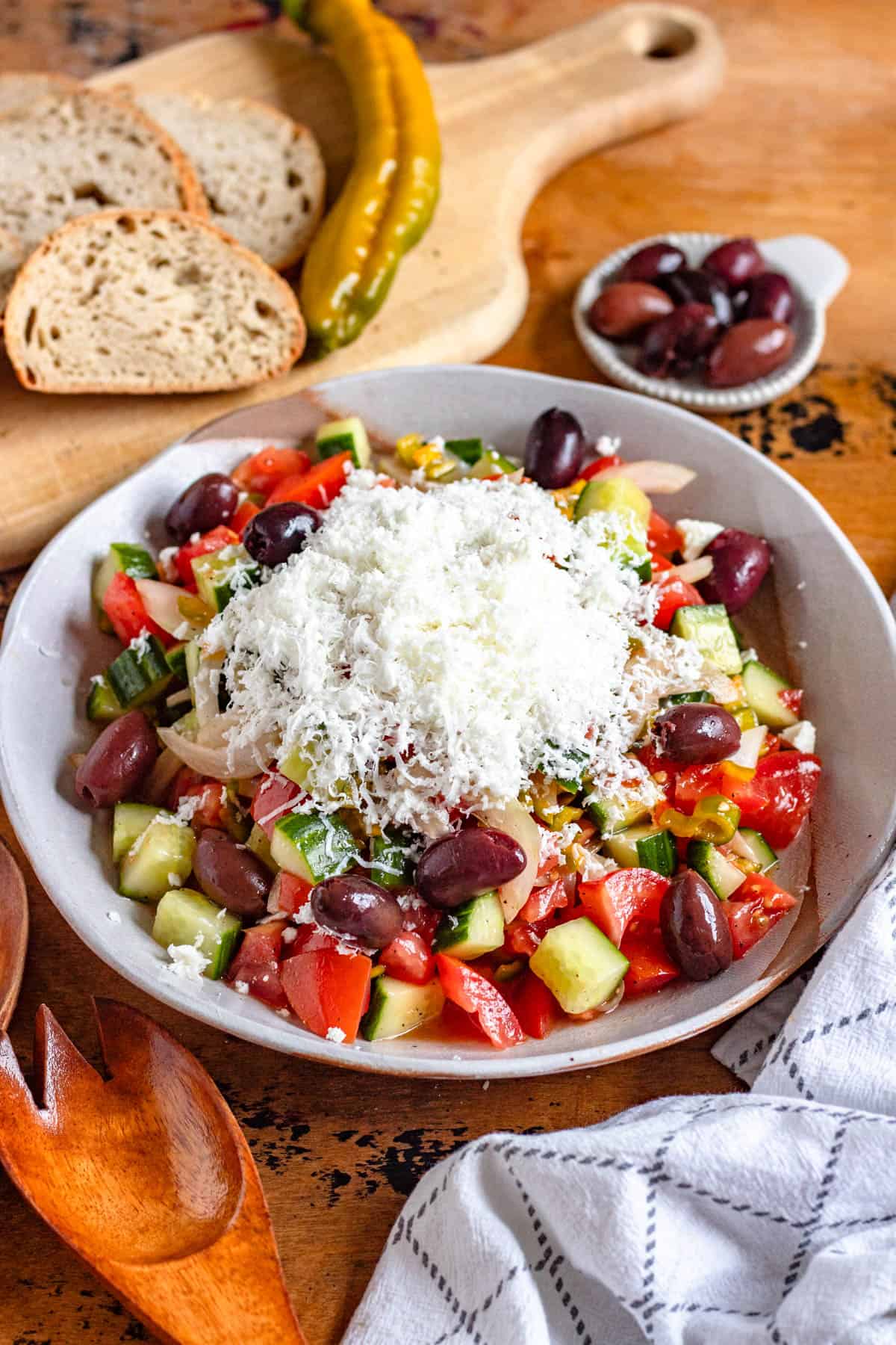 A bowl of refreshing Shopska Salad topped with feta cheese.