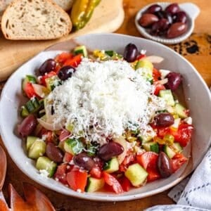 A bowl of refreshing Shopska Salad topped with feta cheese.