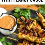 Pinterest image of Chicken Satay showing chicken skewers on a plate next to peanut sauce.