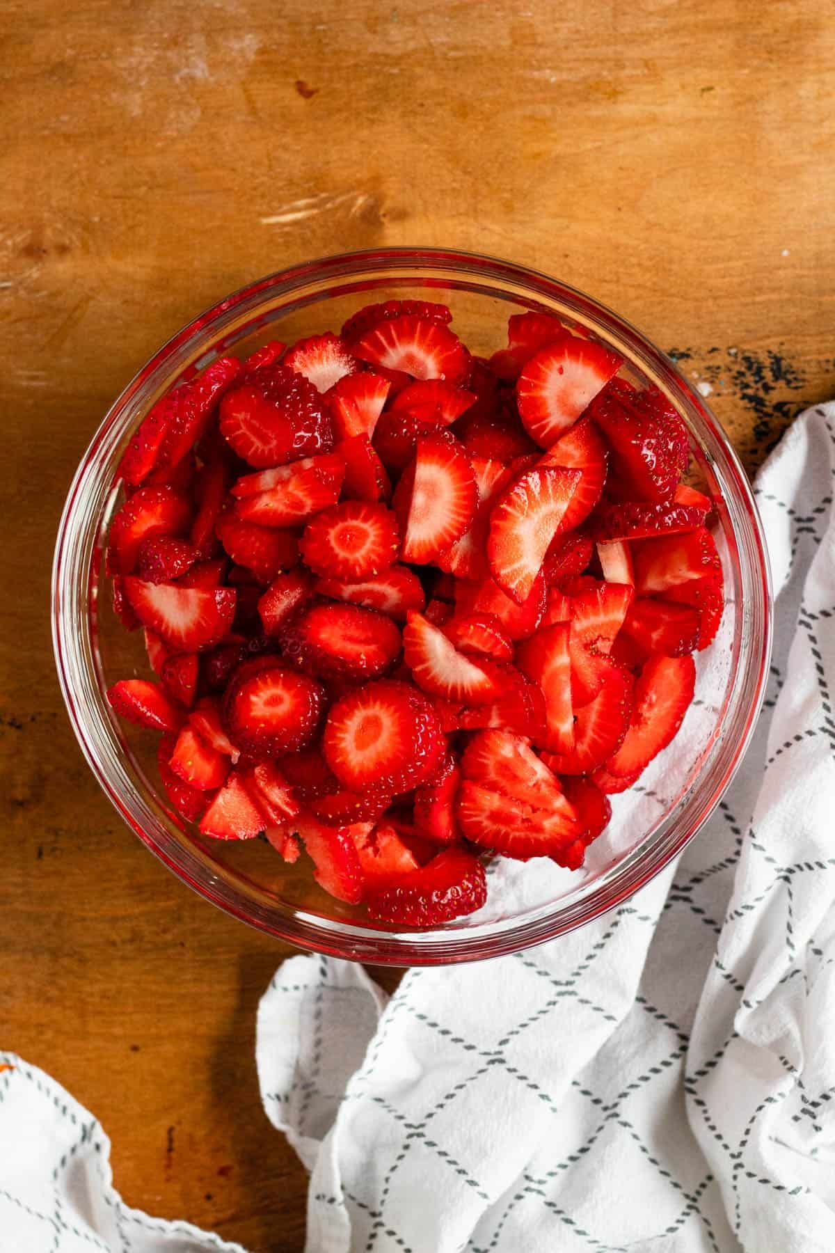 A bowl filled with fresh strawberry slices.