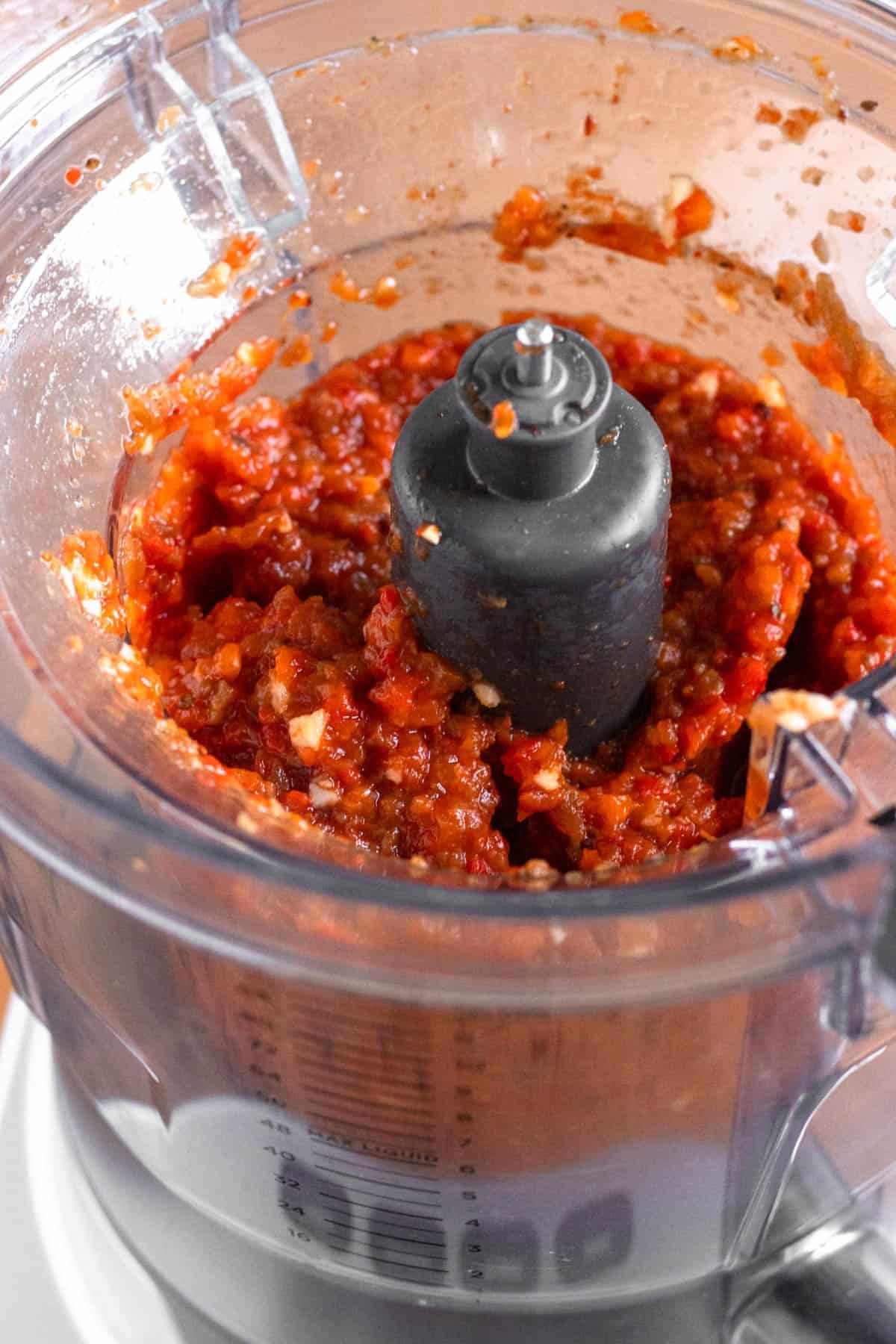 Smoothly blended red bell peppers and eggplant in a blender.