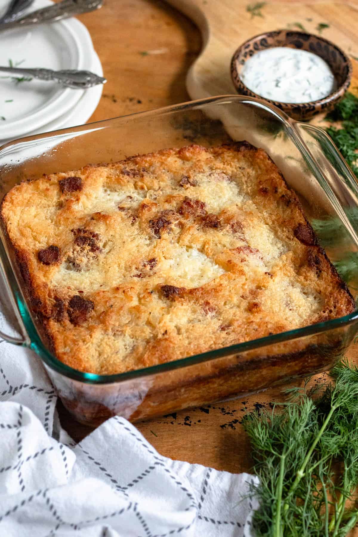 Golden-brown baked potato kugelis in a glass dish.