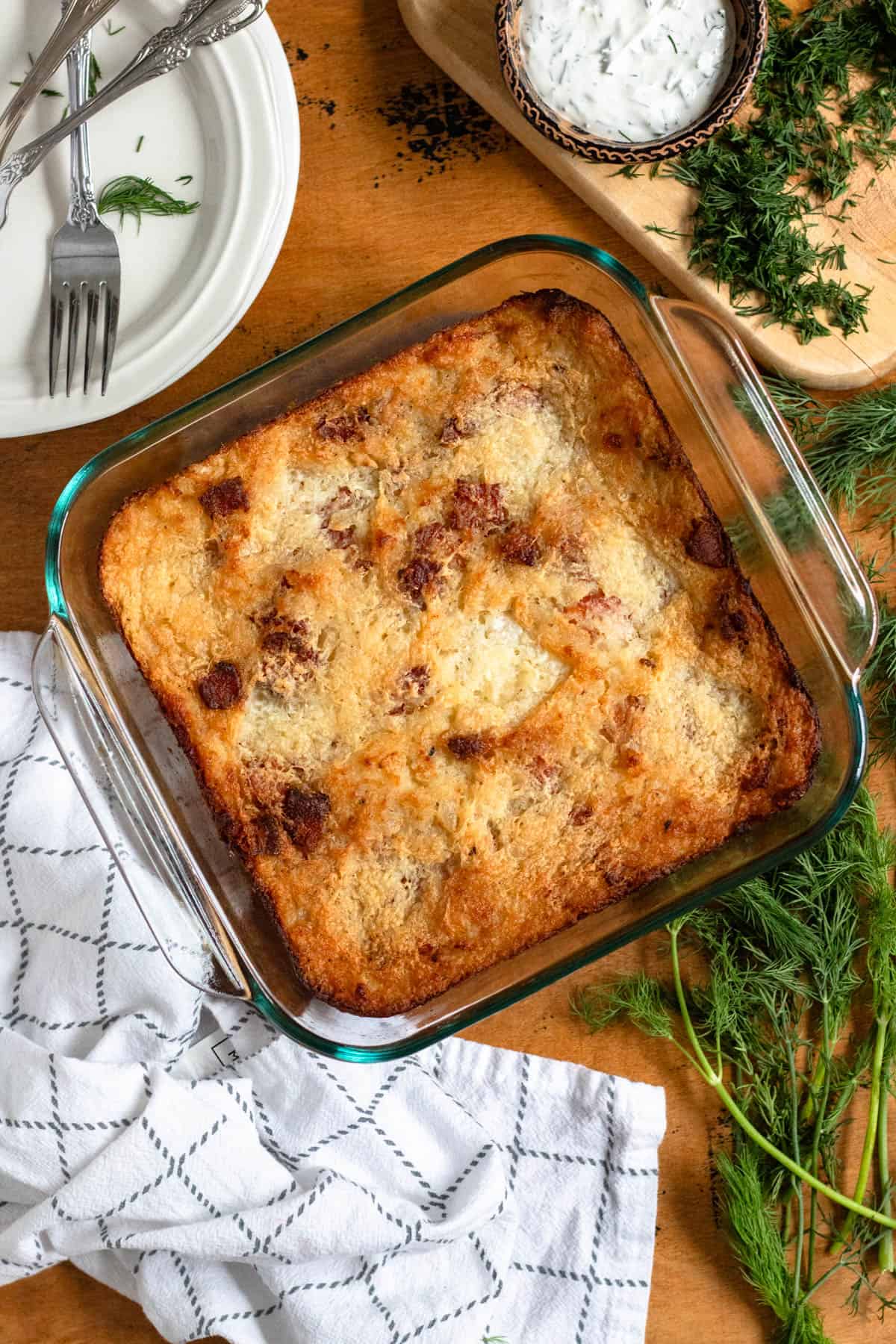 Golden-brown baked potato kugelis in a glass dish.
