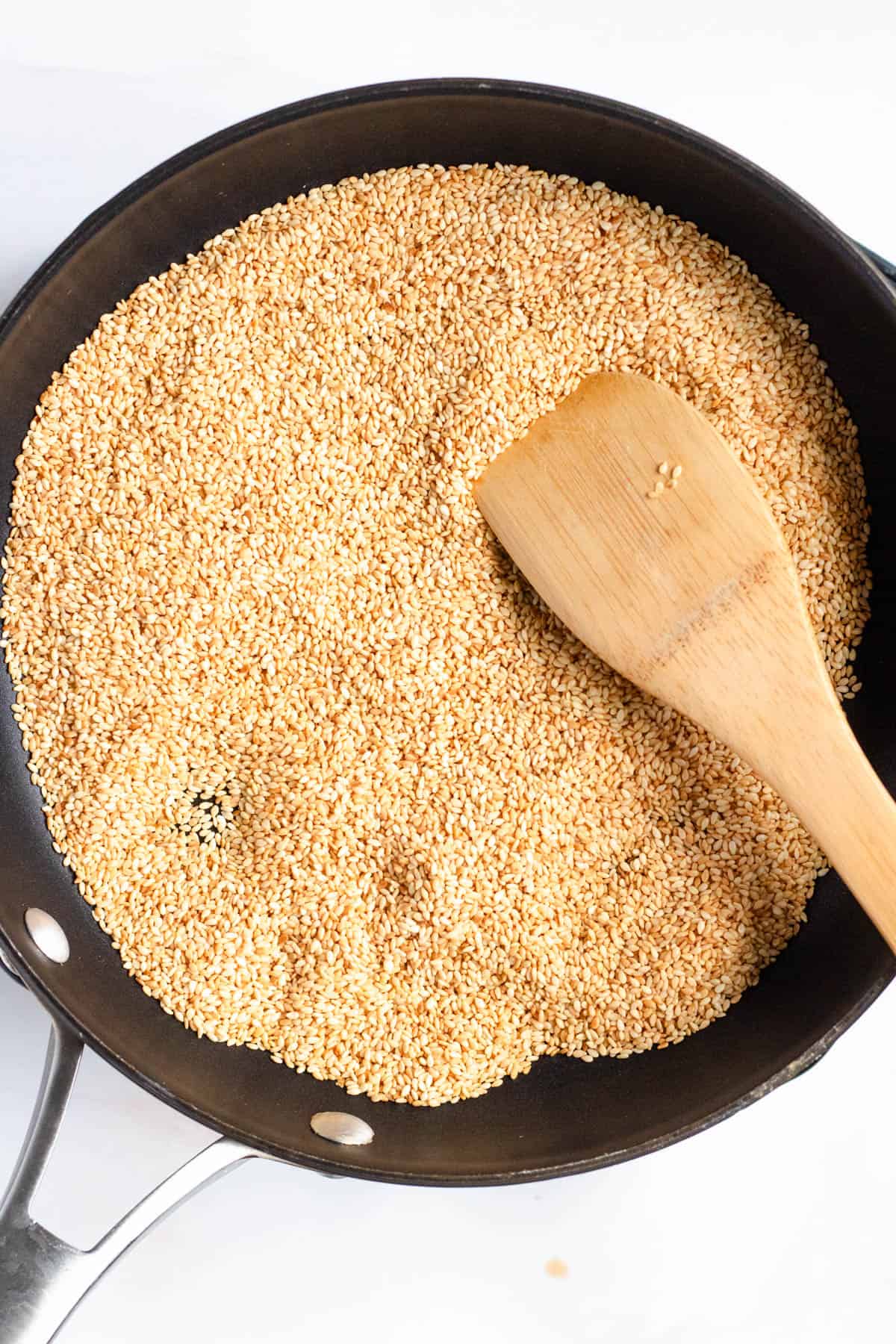 Toasting sesame seeds in a non-stick skillet.