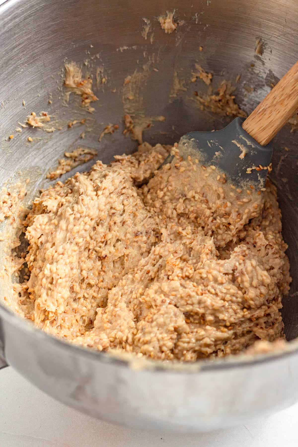 Toasted sesame seeds being folded into the batter.