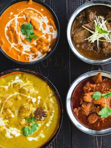 Top image of butter chicken and tikka masala bowls on a dark wooden table.