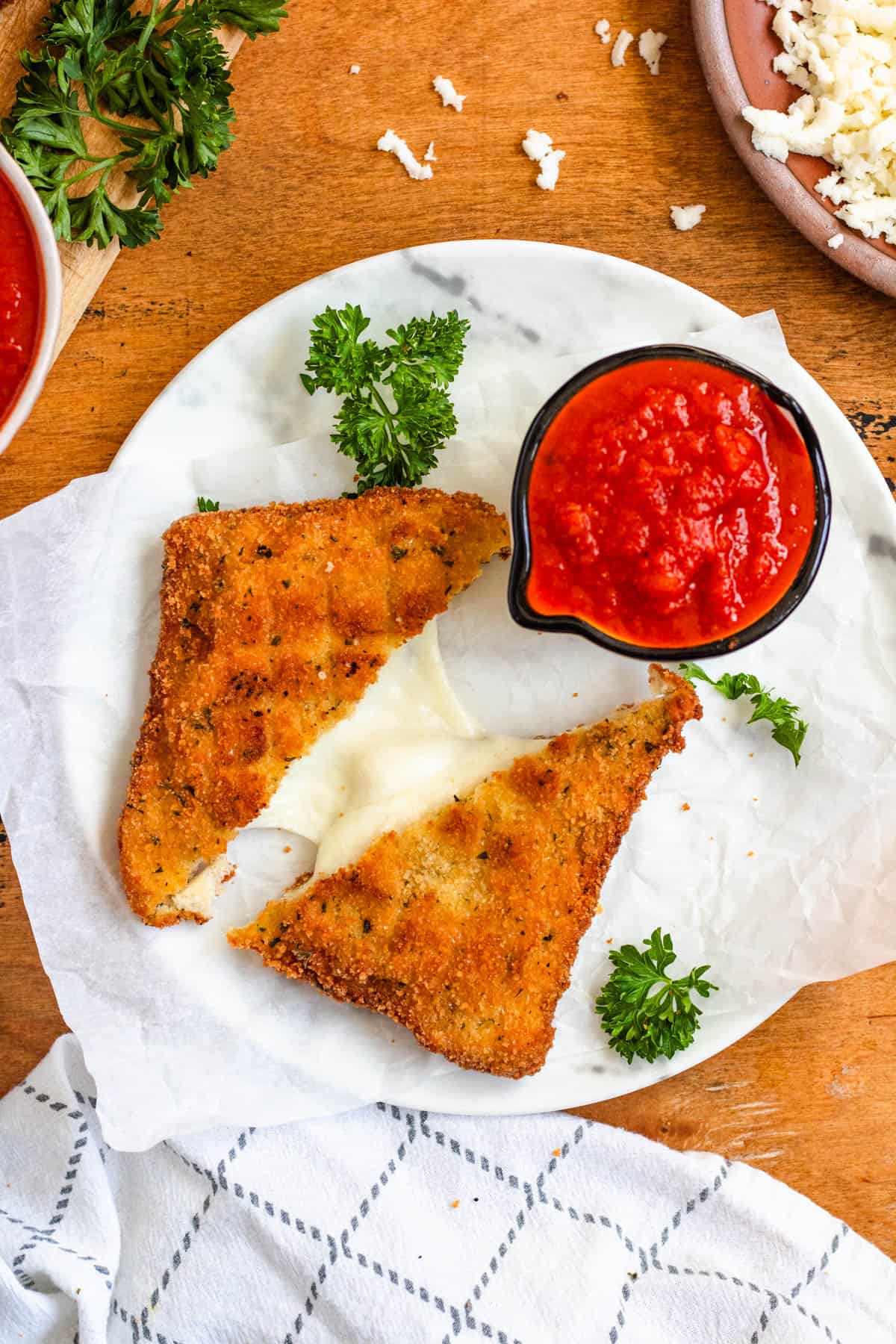 Crispy Mozzarella in Carrozza halves served hot with marinara sauce.