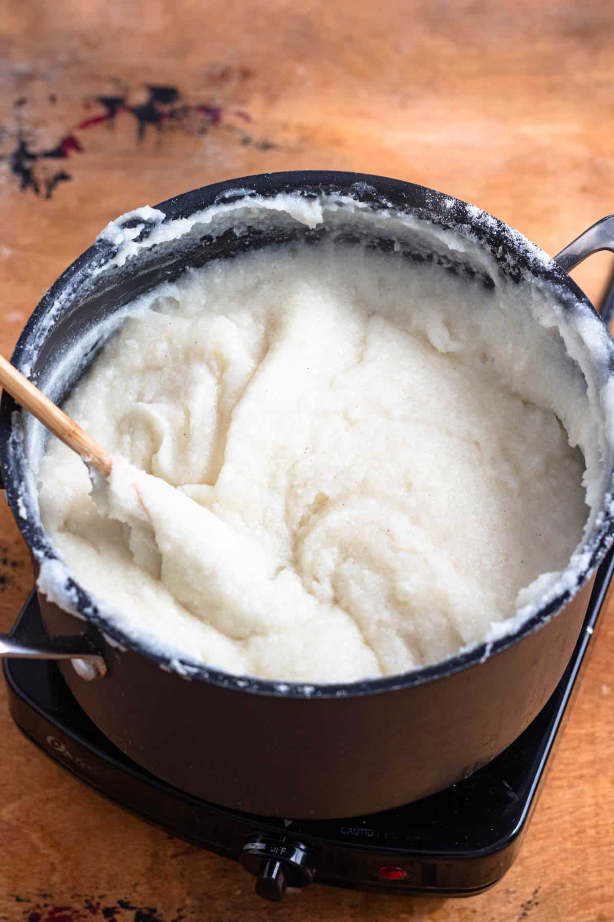 Cornmeal mixture thickening in the pot.