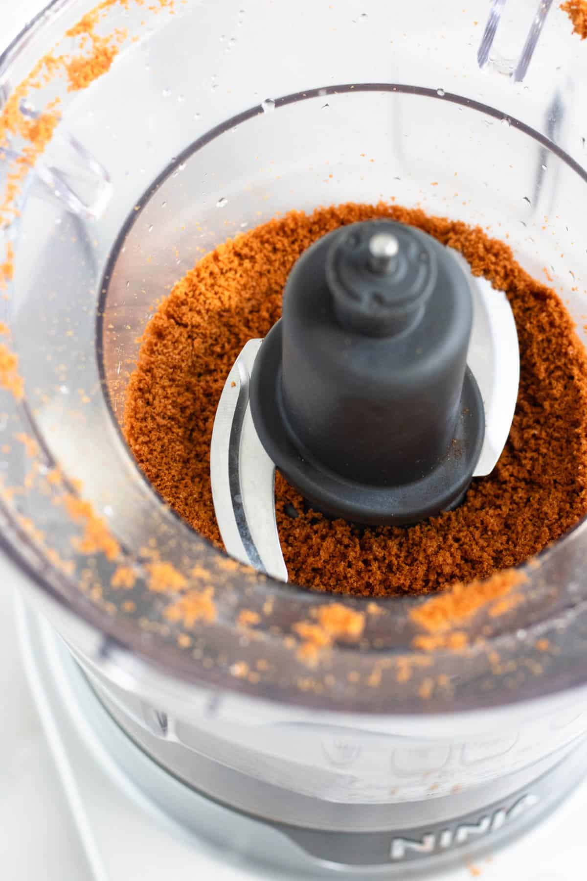 Finely crushed Lotus Biscoff cookie crumbs blended in a food processor.