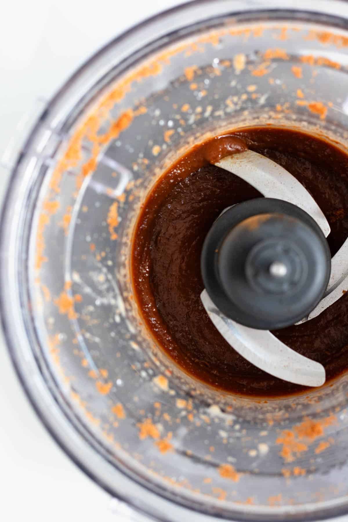 A smooth, blended cookie butter mixture in a food processor.
