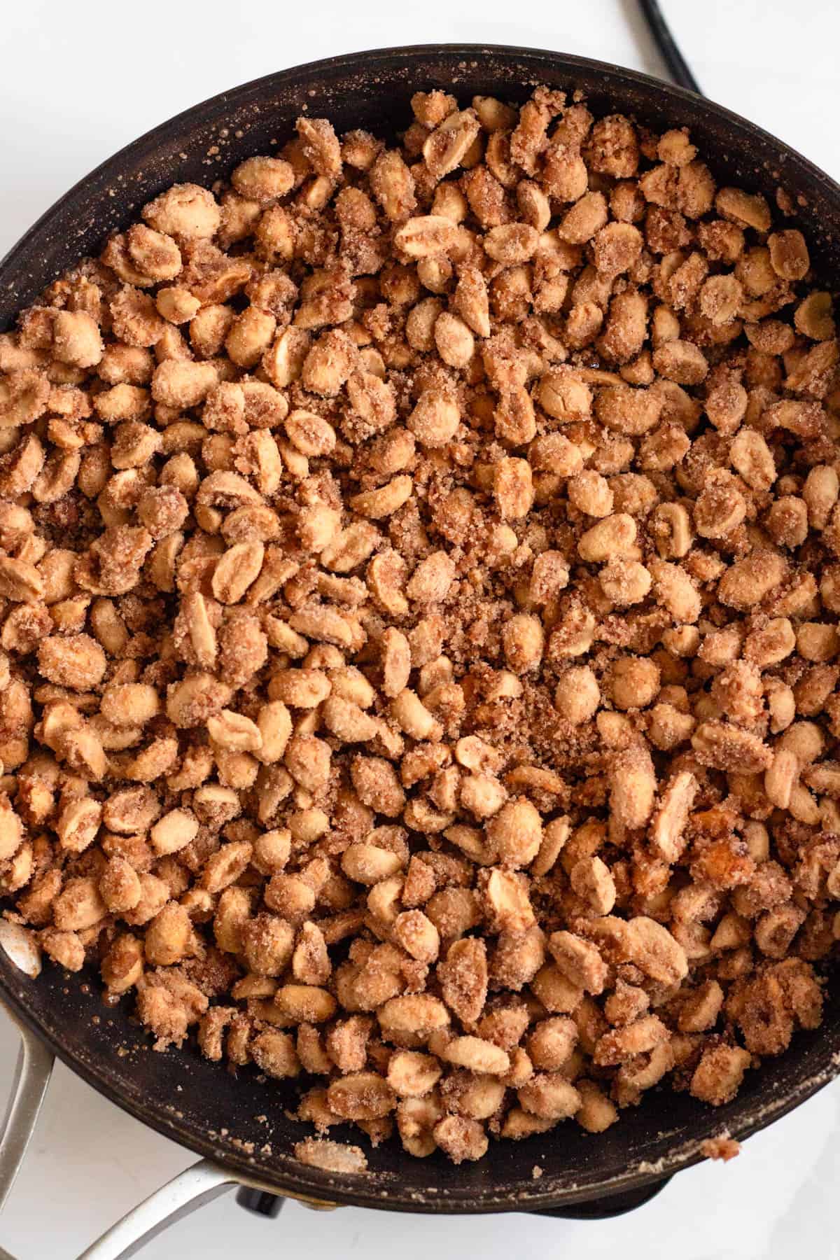 A pan filled with freshly made candied peanuts.