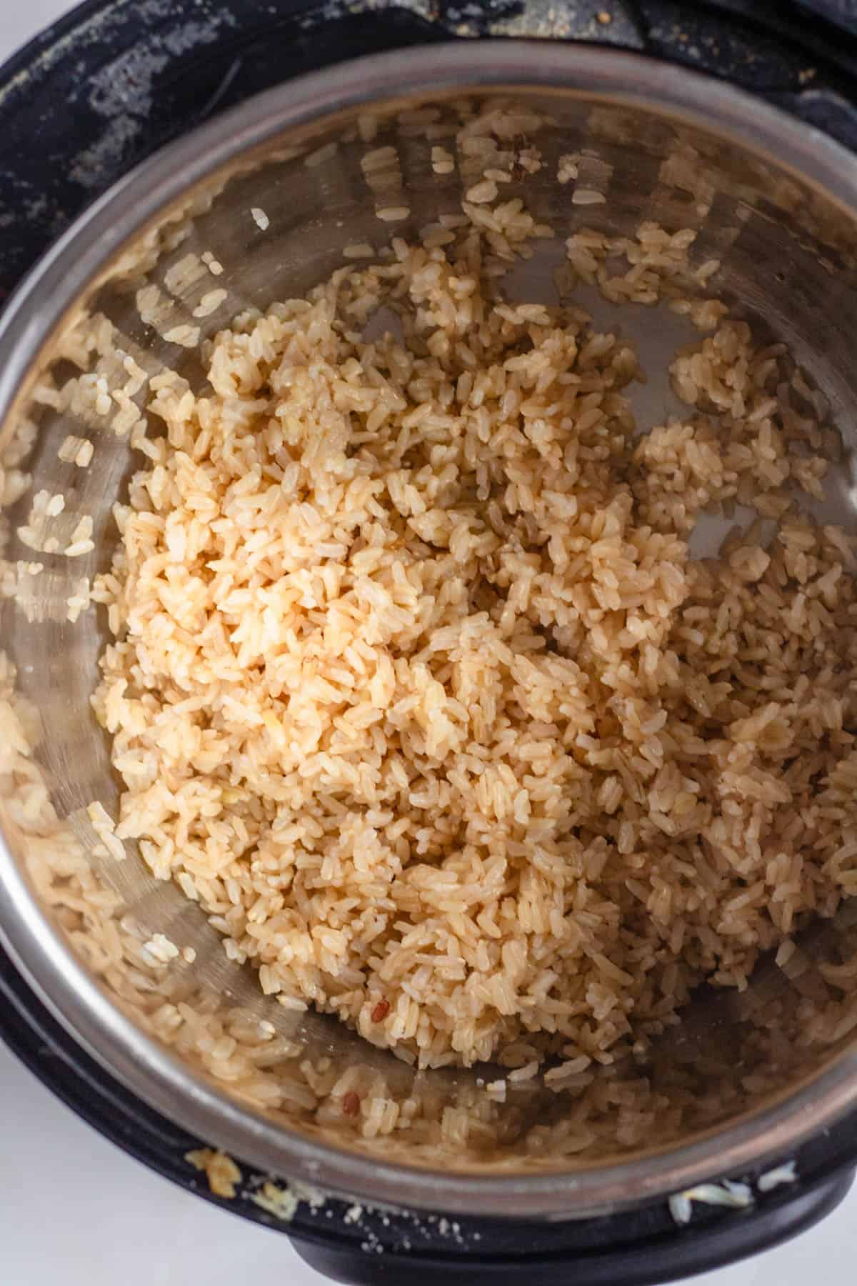 Cooked brown rice inside an Instant Pot after fluffing.
