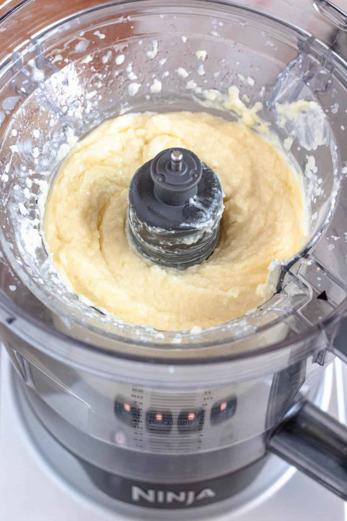 Oil added to the toum mixture in the food processor. 