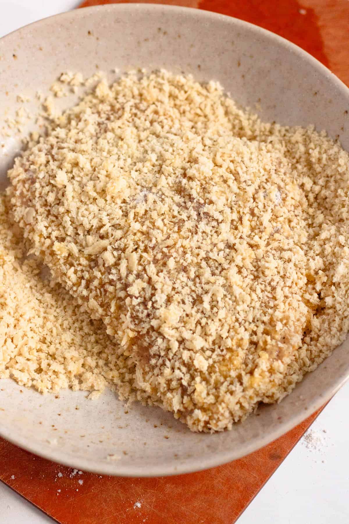 Chicken cutlets coated evenly in panko breadcrumbs on both sides.
