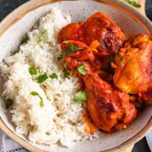 Coconut Curry Chicken served with white rice and fresh cilantro.
