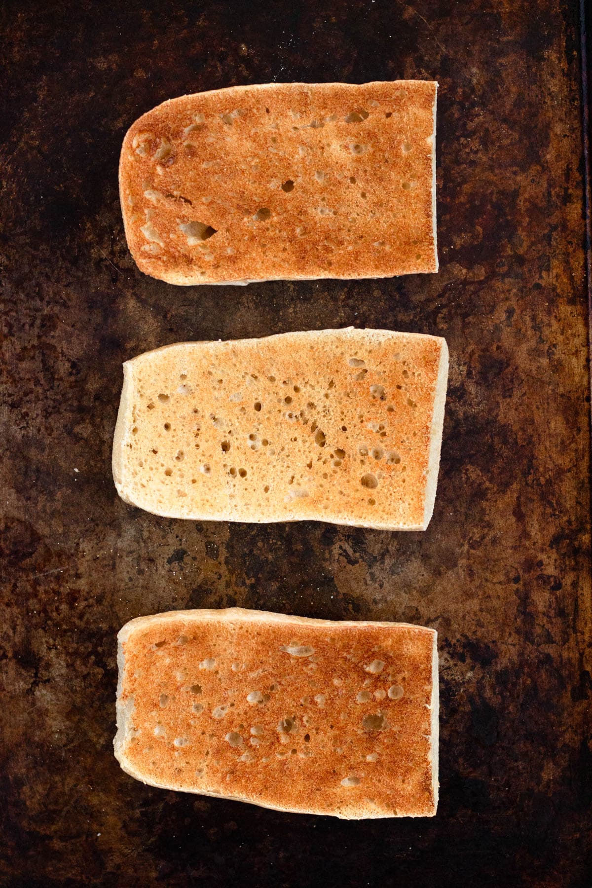 Bread slices lightly toasted in the oven until golden brown.
