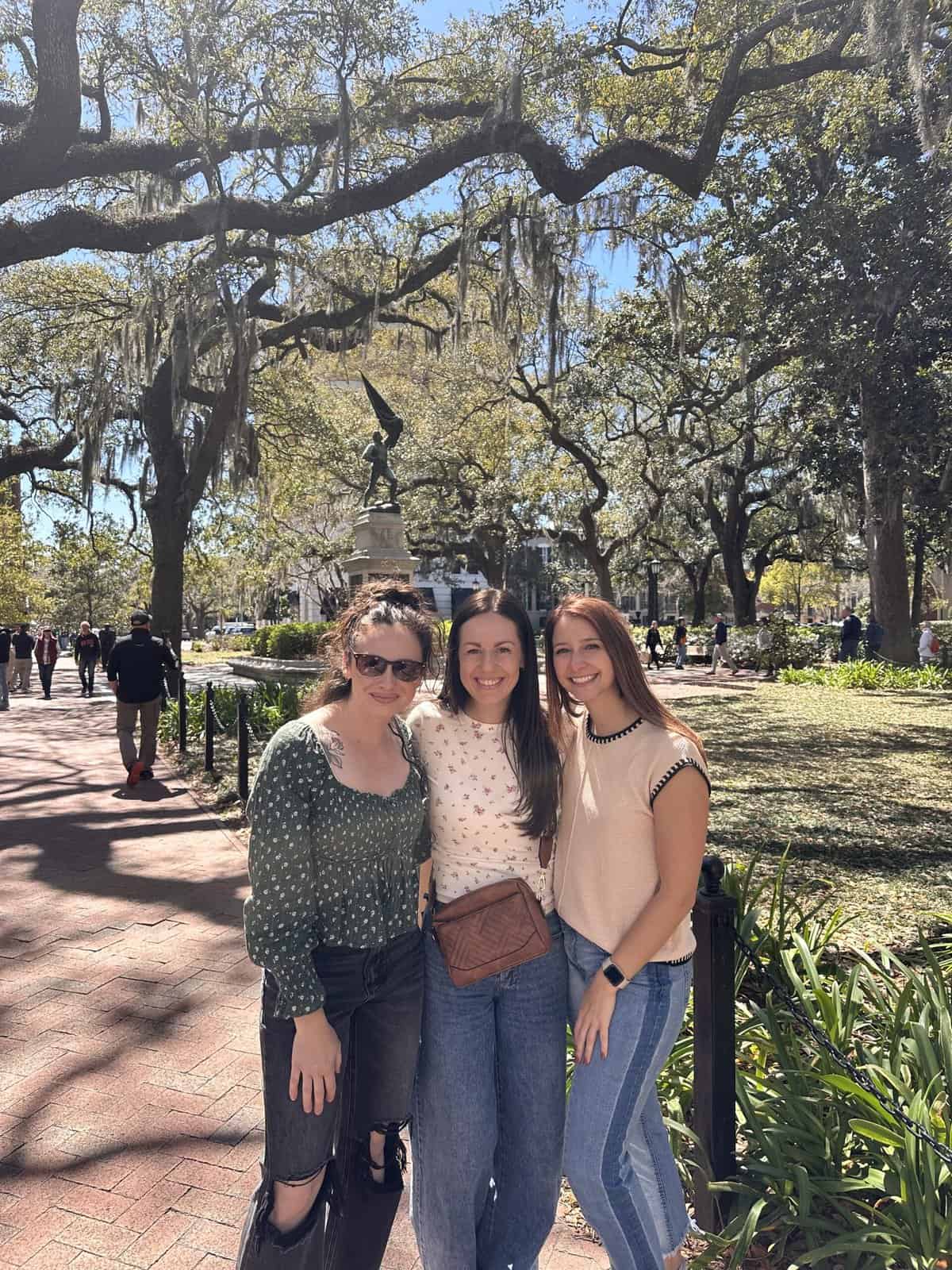 3 friends smiling in a park in savannah
