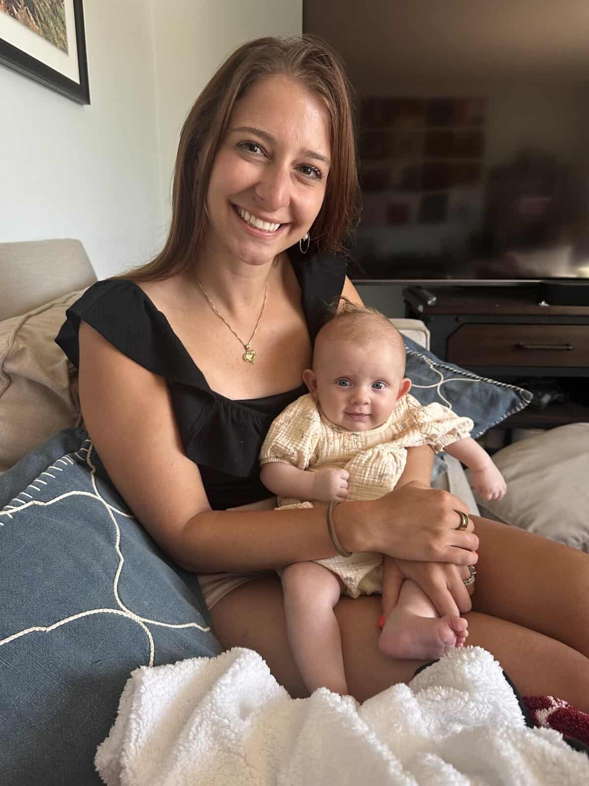A girl holding a baby 