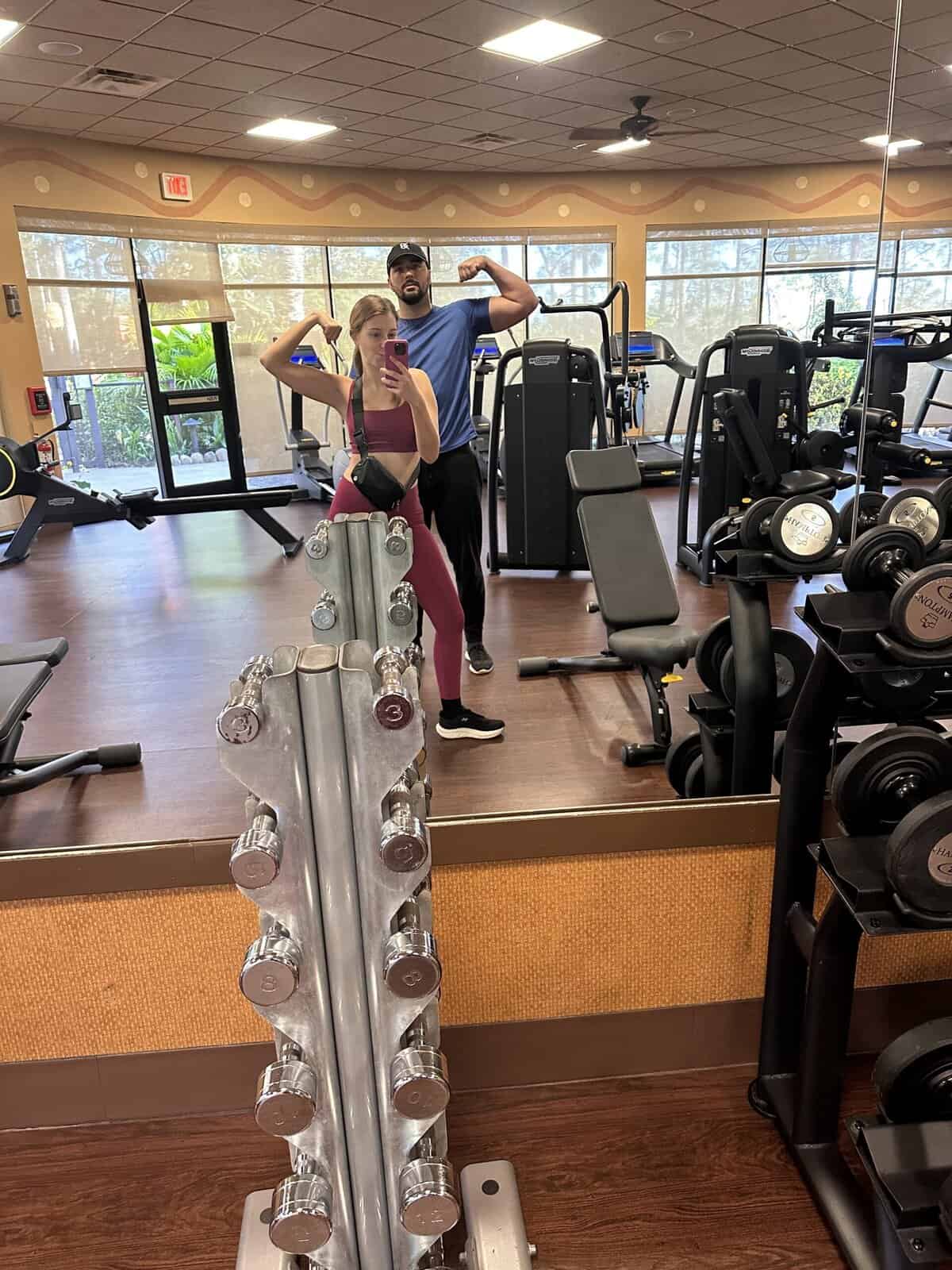 A couple working out in a gym and flexing