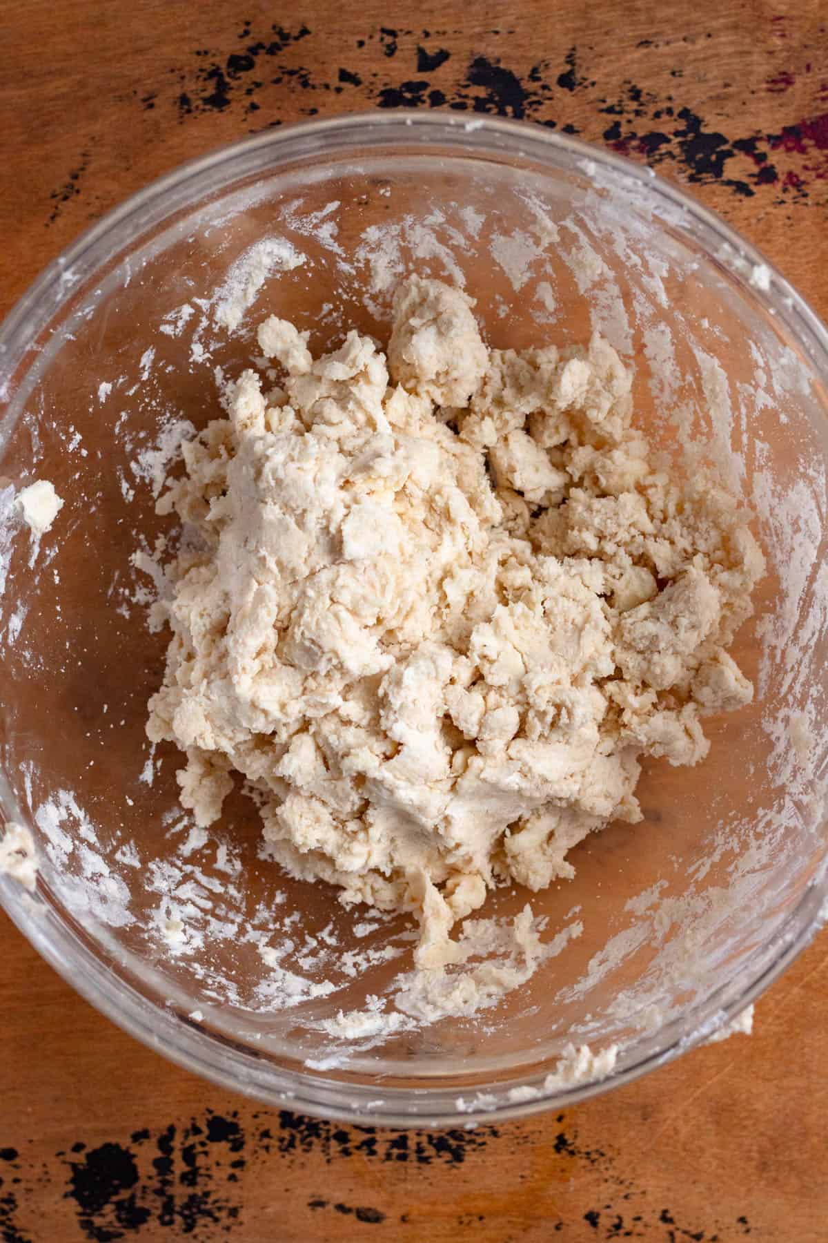 Flour, salt, butter, lard, ice water, and sour cream combined into a rough, shaggy dough.