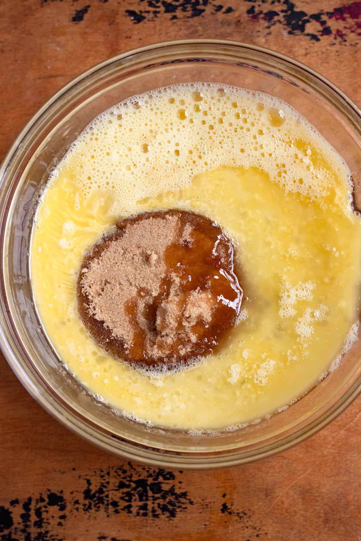 Whisked eggs combined with brown sugar and corn syrup, then drizzled with melted butter, vanilla, and lemon juice.
