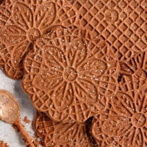 Chocolate Pizzelles lightly dusted with powdered sugar.