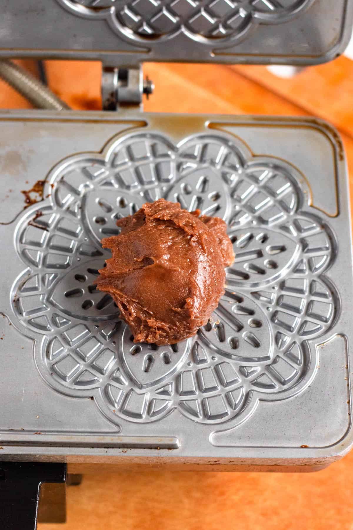 Tablespoon of batter dropped onto the hot pizzelle maker.