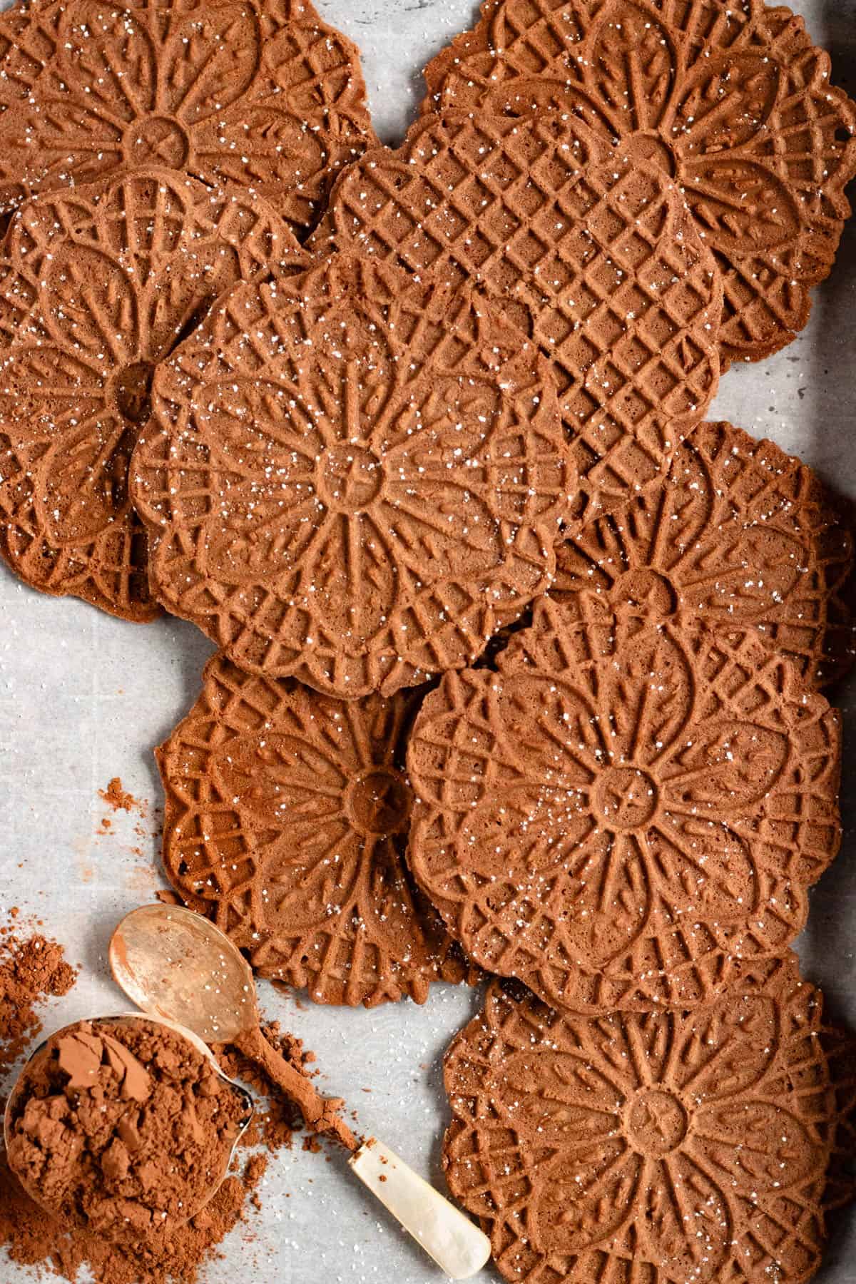 Chocolate Pizzelles lightly dusted with powdered sugar.