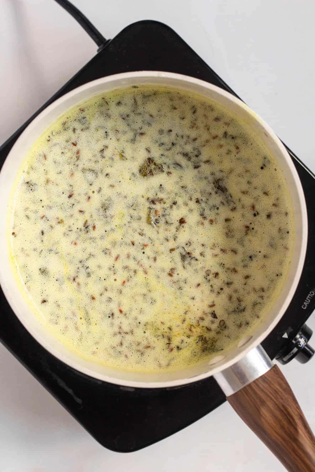 Spices being stirred into melted butter.