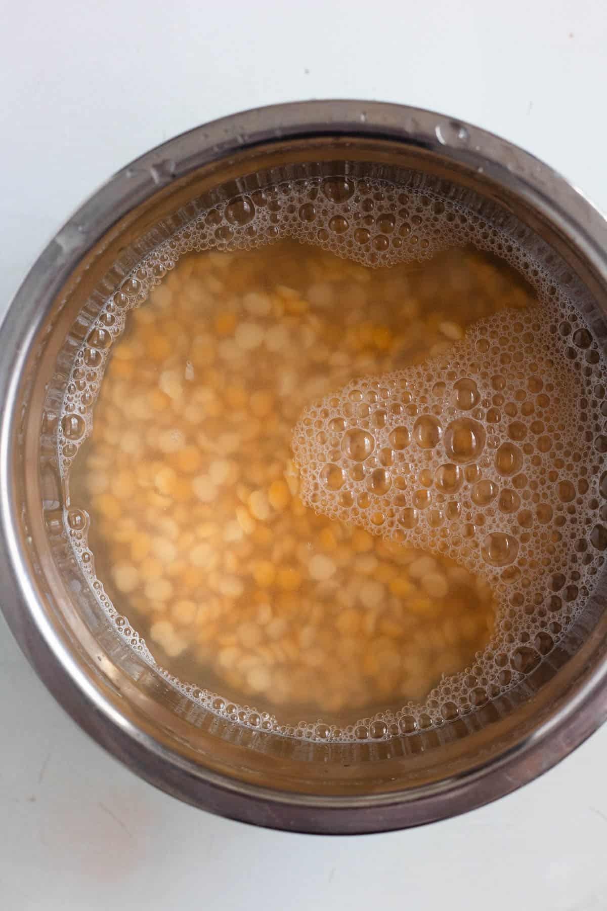 Split peas soaking in water in a bowl.